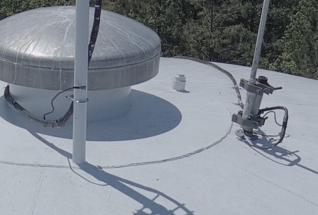 A white roof with a dome on top of it.
