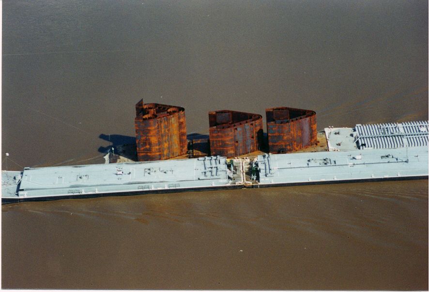 An aerial view of a rusty ship in the water