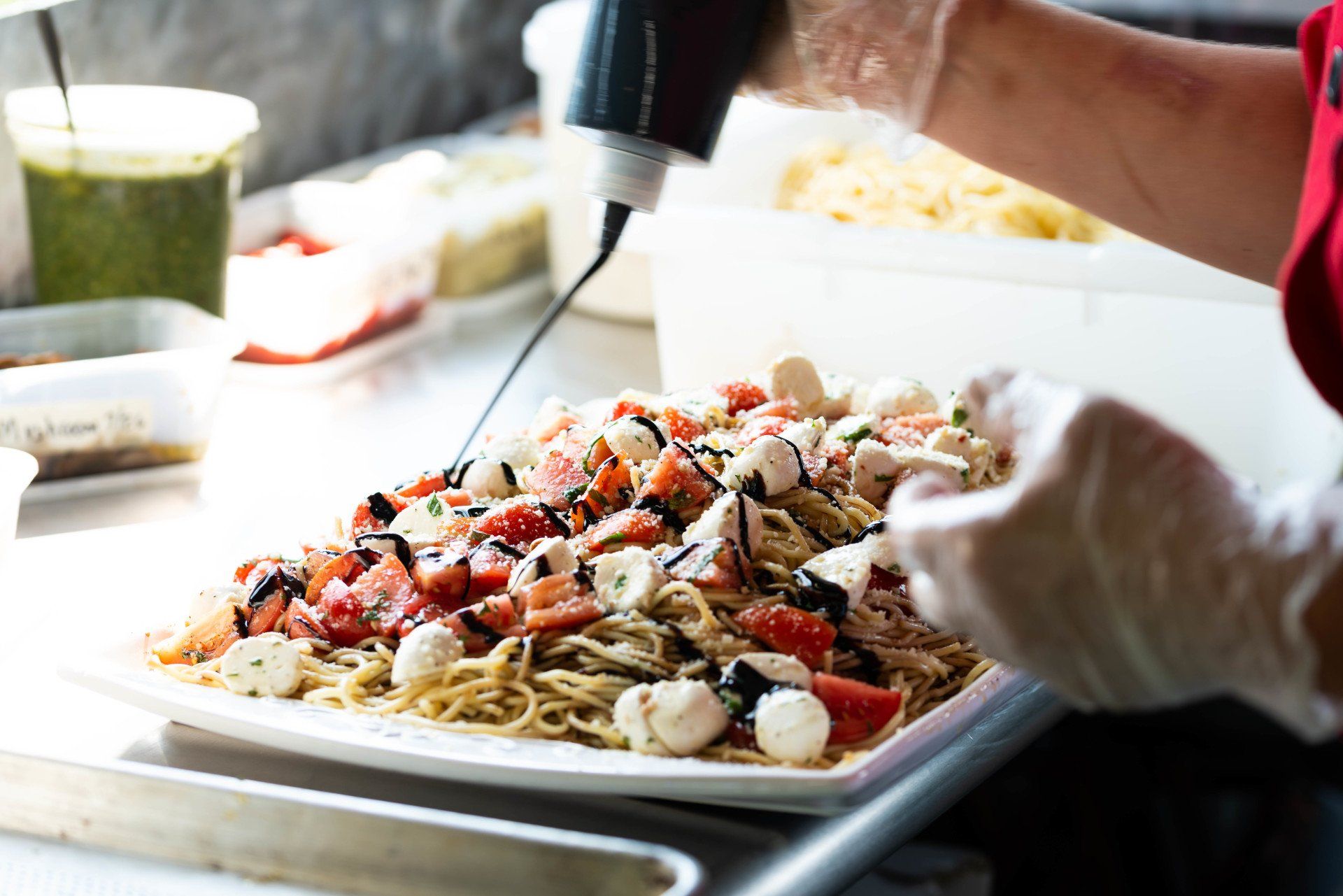 Spaghetti with fresh mozzarella balls, sliced tomatoes, and a balsamic vinaigrette drizzle.