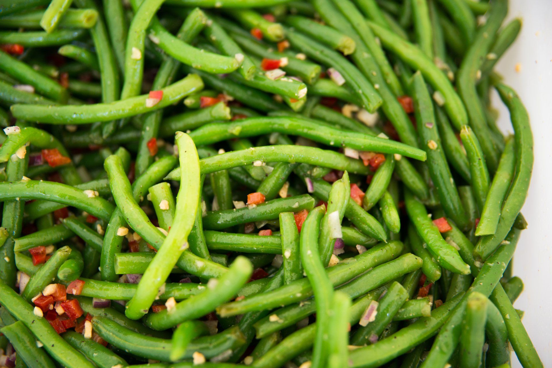 Fresh sauteed green beans with savory garlic and red peppers.