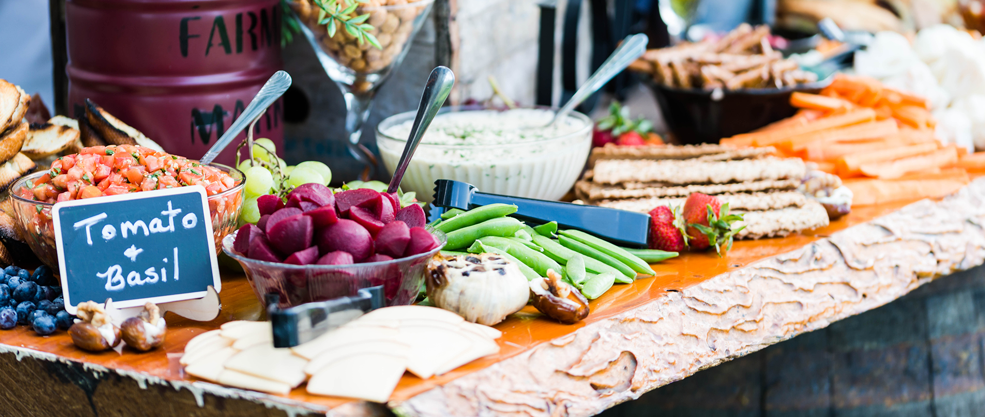 Luncheon cheeseboard with swiss and aged cheddar, gourmet crackers, fresh grapes and strawberries.