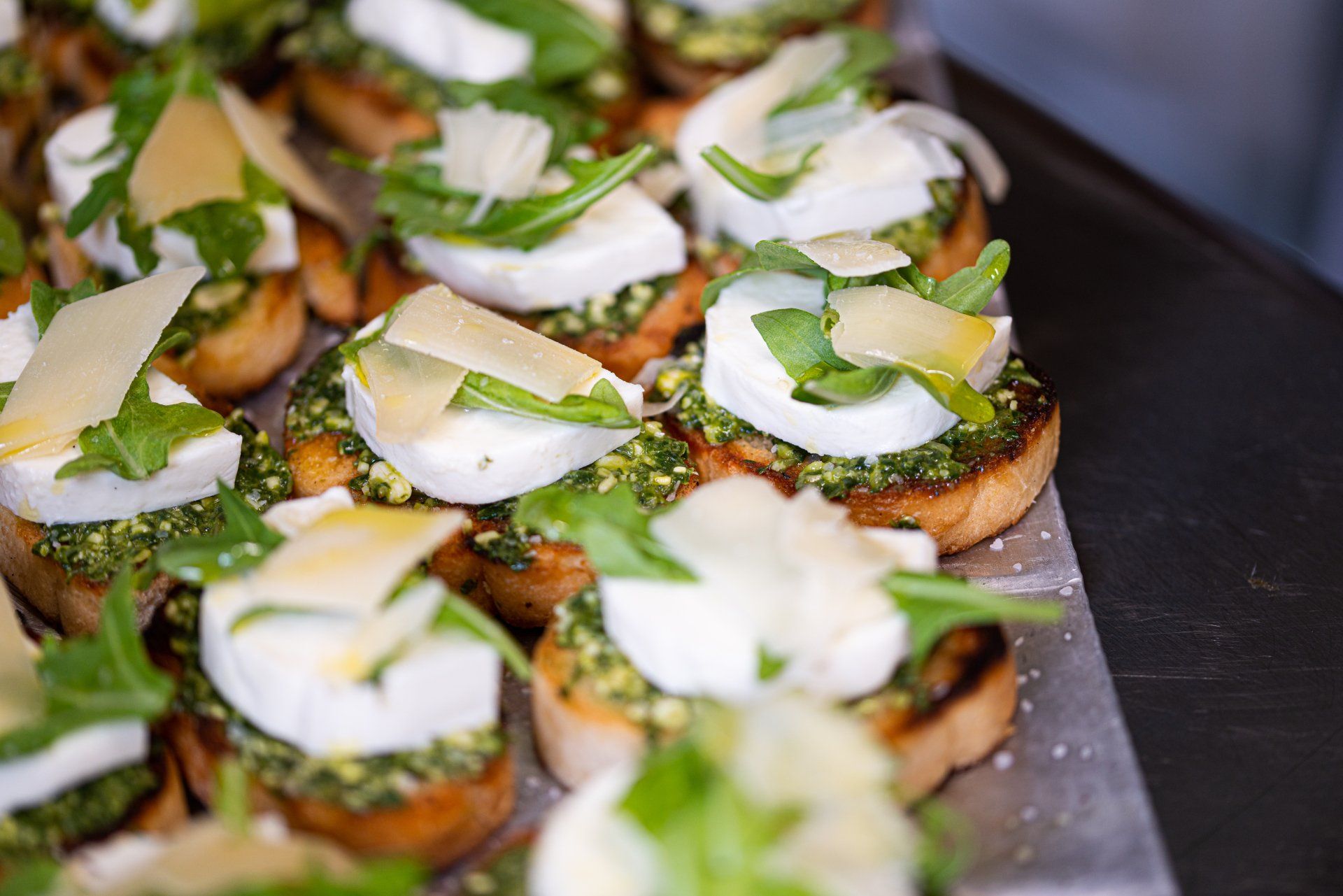 Delicious kale salad with crumbled feta, carrots, and crunchy tortilla strips. Prepared by For the Love of Food catering.