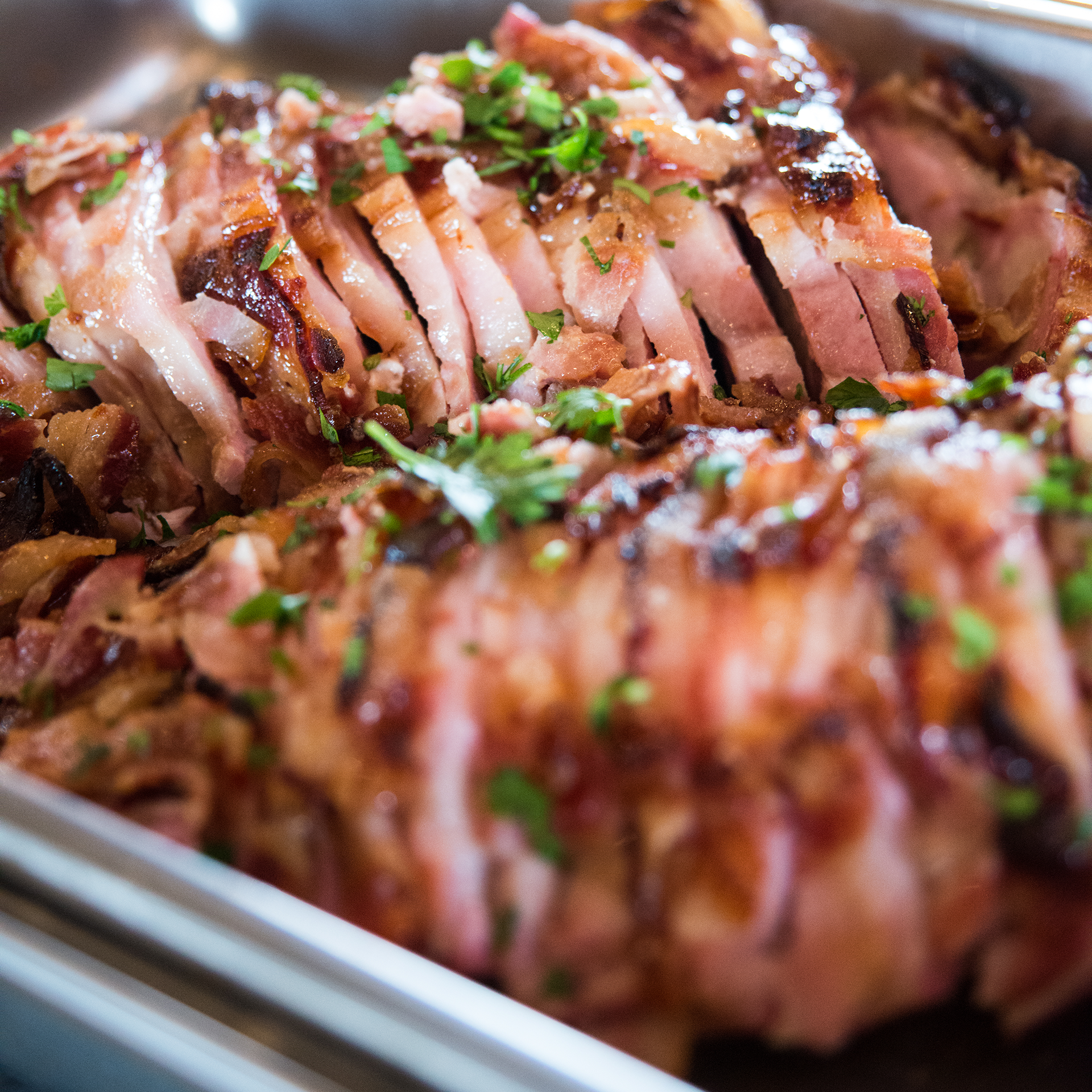 Savory and sweet ham baked to tender perfection, finished with an exquisite glaze and parsley.