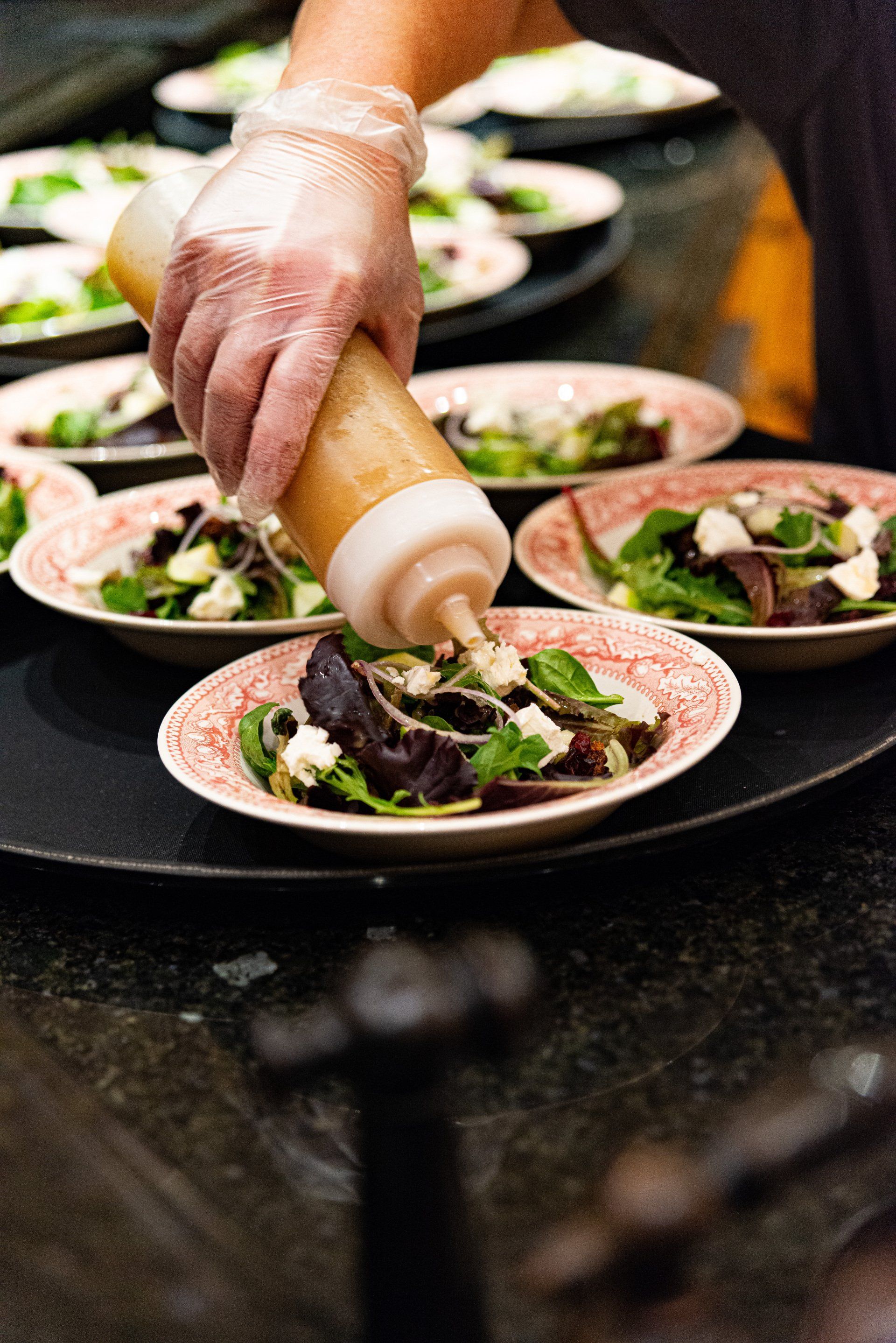 Luncheon cheeseboard with swiss, local honey, kiwis, fresh fruit preserves, aged meats, and almonds.