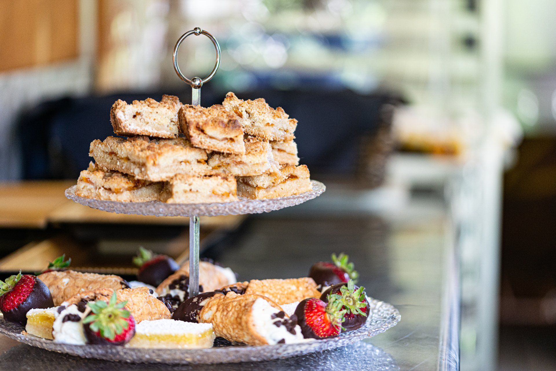 Luncheon cheeseboard with swiss, local honey, kiwis, fresh fruit preserves, aged meats, and almonds.
