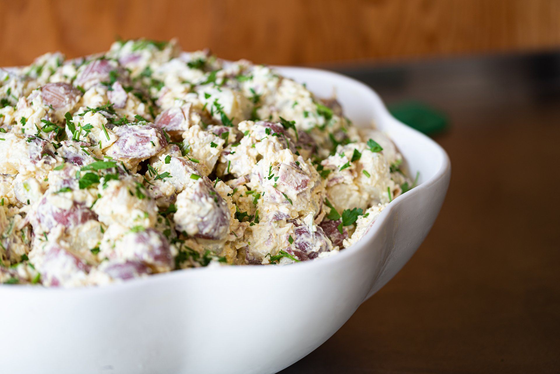 Luncheon cheeseboard with swiss, local honey, kiwis, fresh fruit preserves, aged meats, and almonds.