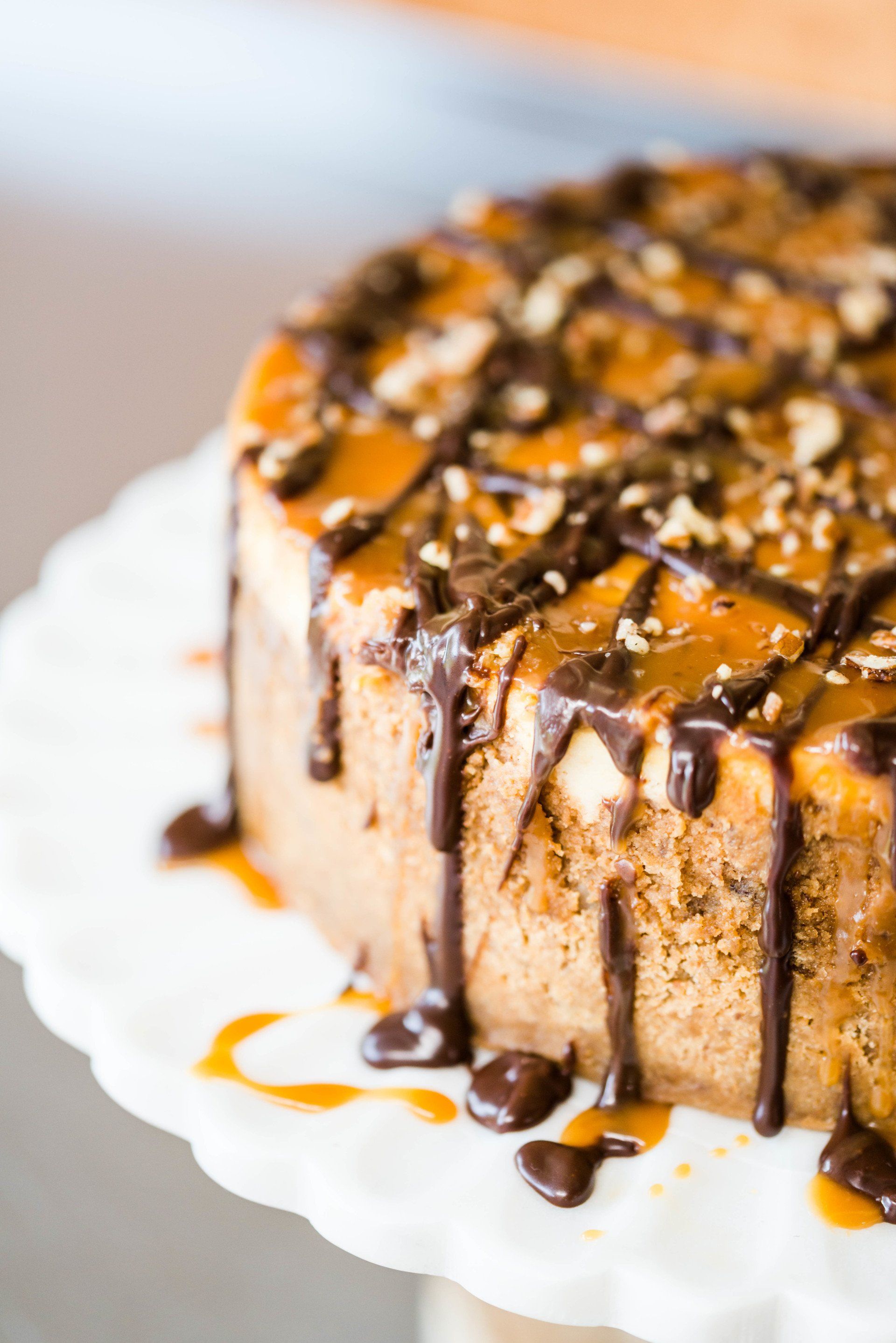 Salted caramel cake with a homemade chocolate drizzle and finely chopped nut topping.