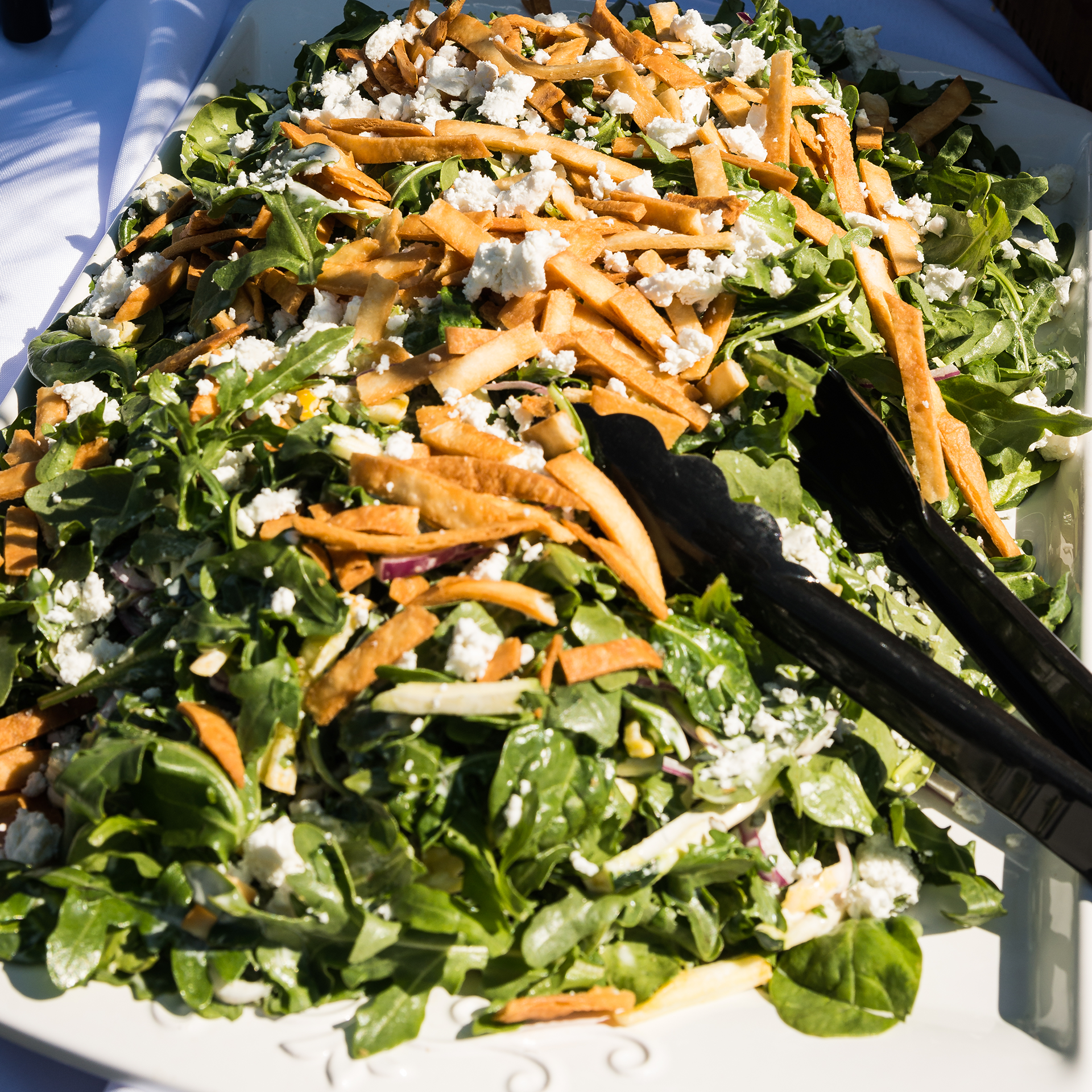 Fresh kale salad with crumbled feta and carrots.