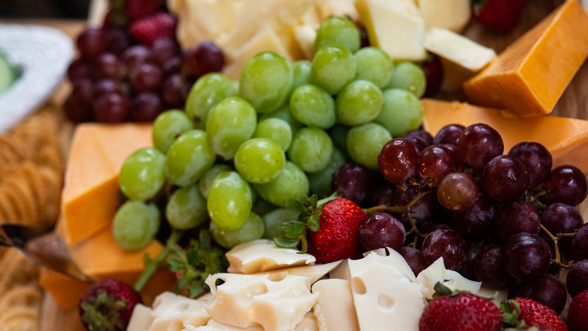 Fresh grapes and flaked parmesan cheese in a savory luncheon  display.