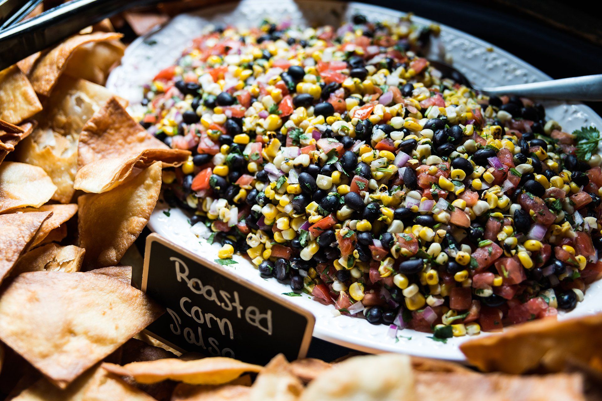 Fresh corn and black bean salad with diced tomatoes and cilantro.