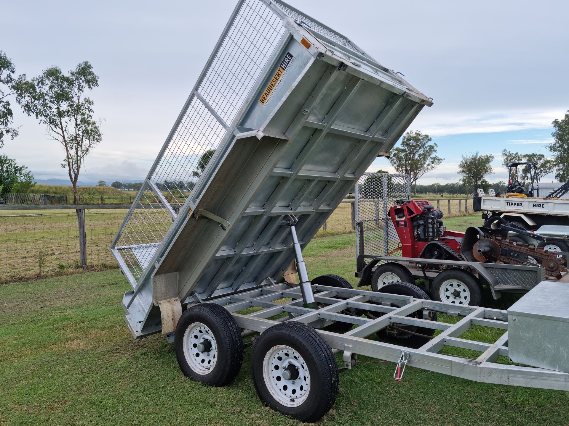 Dump Car Trailer Unloading Garden Soil — Beaudesert Equipment Hire Services in Beaudesert, QLD