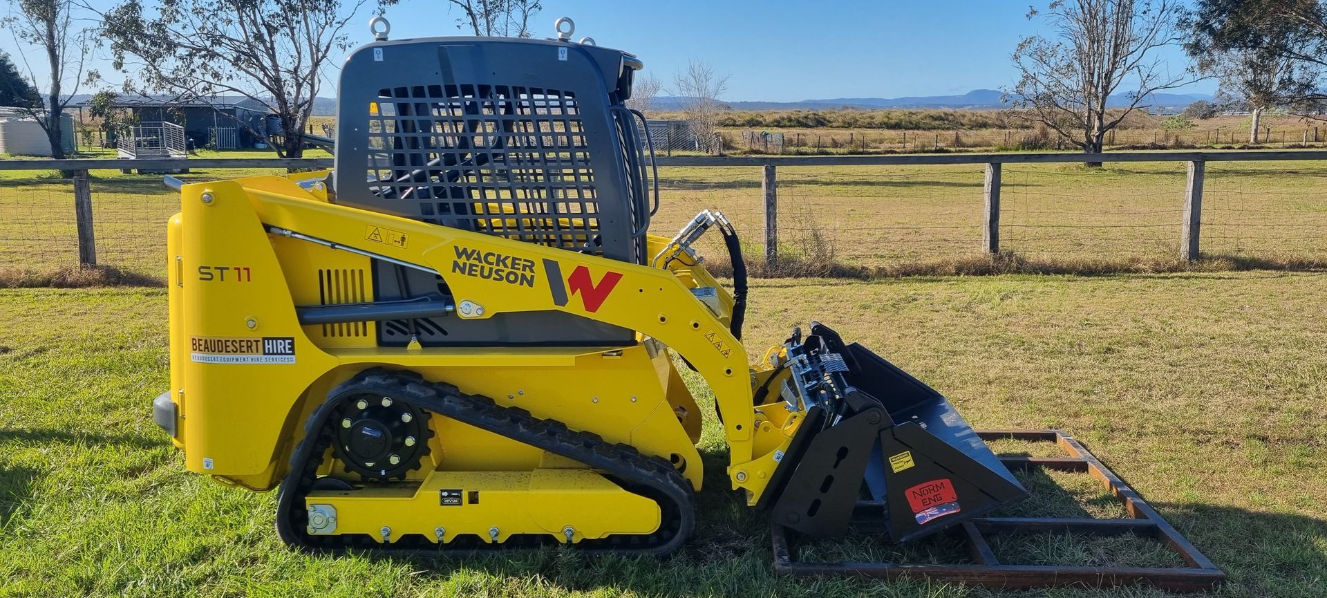 Skid Steer Loader Moving Soil at Construction Area — Beaudesert Equipment Hire Services in Beaudesert, QLD