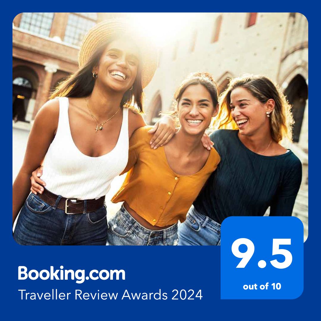 three women are standing next to each other on a blue sign that says booking.com traveller review awards 2024