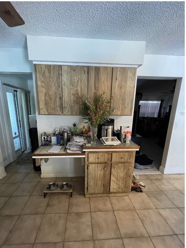 A kitchen with wooden cabinets and a sink.