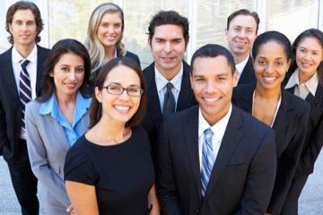 A group of business people are posing for a picture together.