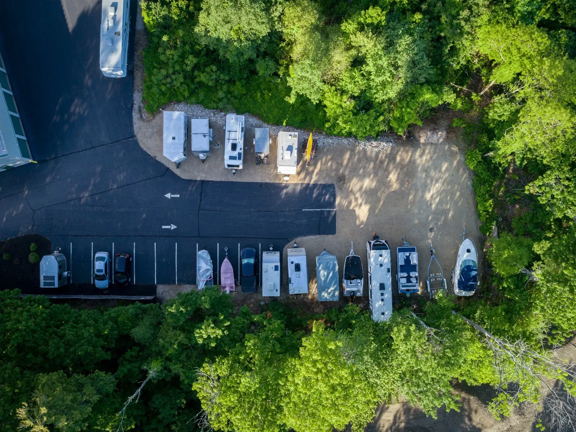 An aerial view of a parking lot surrounded by trees.