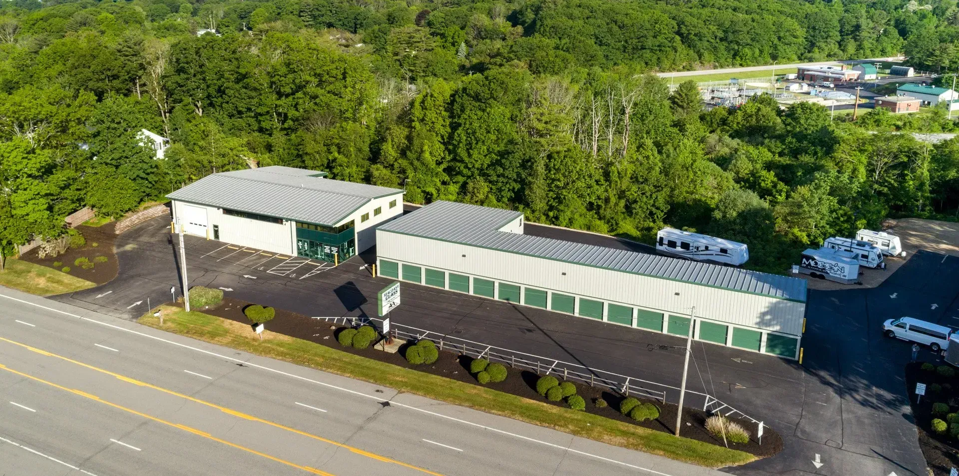 An aerial view of a storage facility next to a highway.