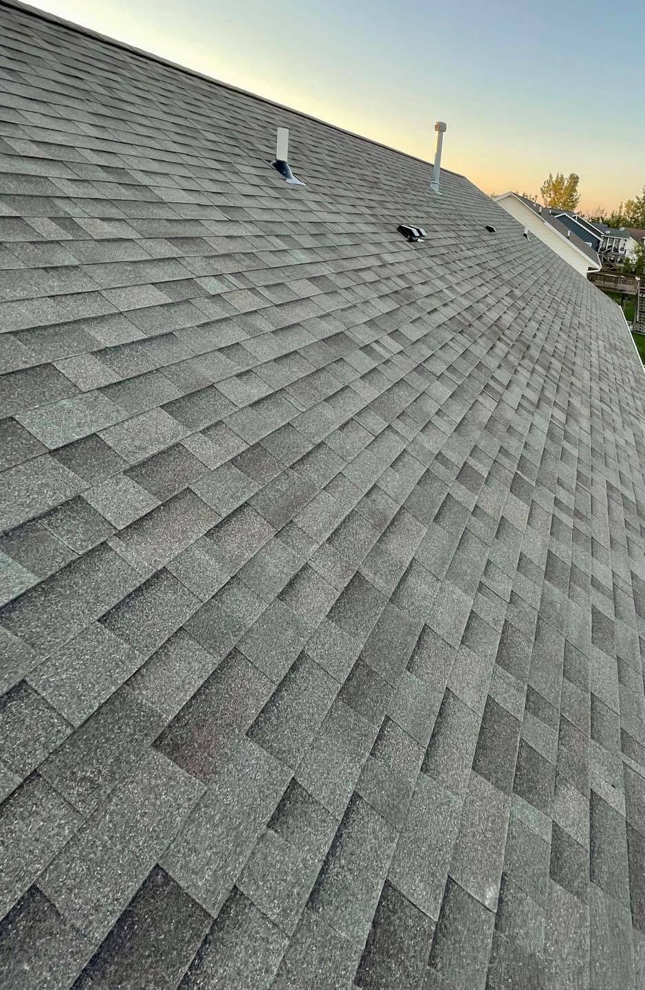 Man inspecting roof — Cedar Rapids, IA — Baker Pro Construction, LLC