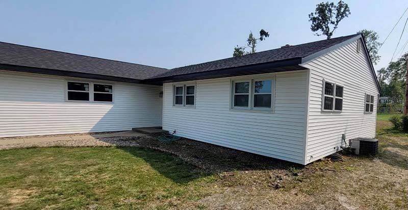 Side view of white house with gray roof — Cedar Rapids, IA — Baker Pro Construction, LLC