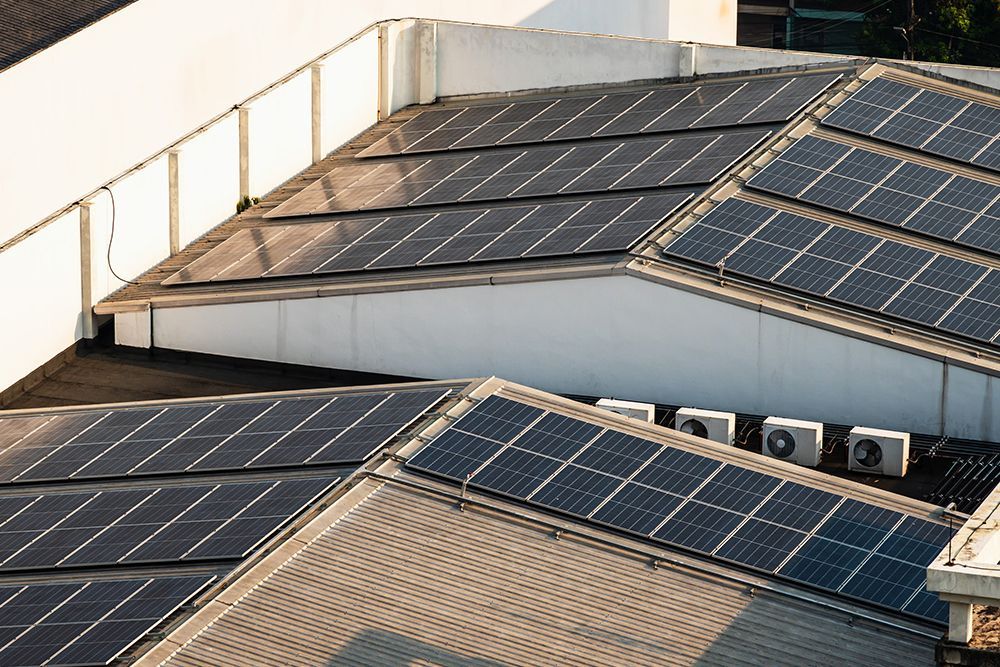 Solar panels on a commercial building roof, capturing sunlight for energy.