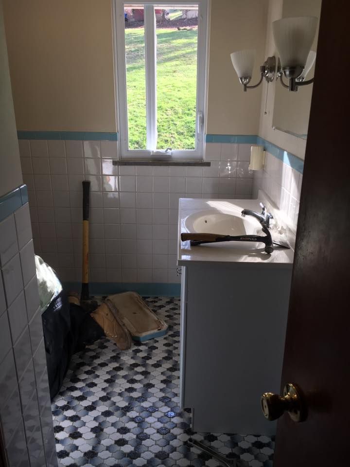 A bathroom with a sink and a hammer on the counter