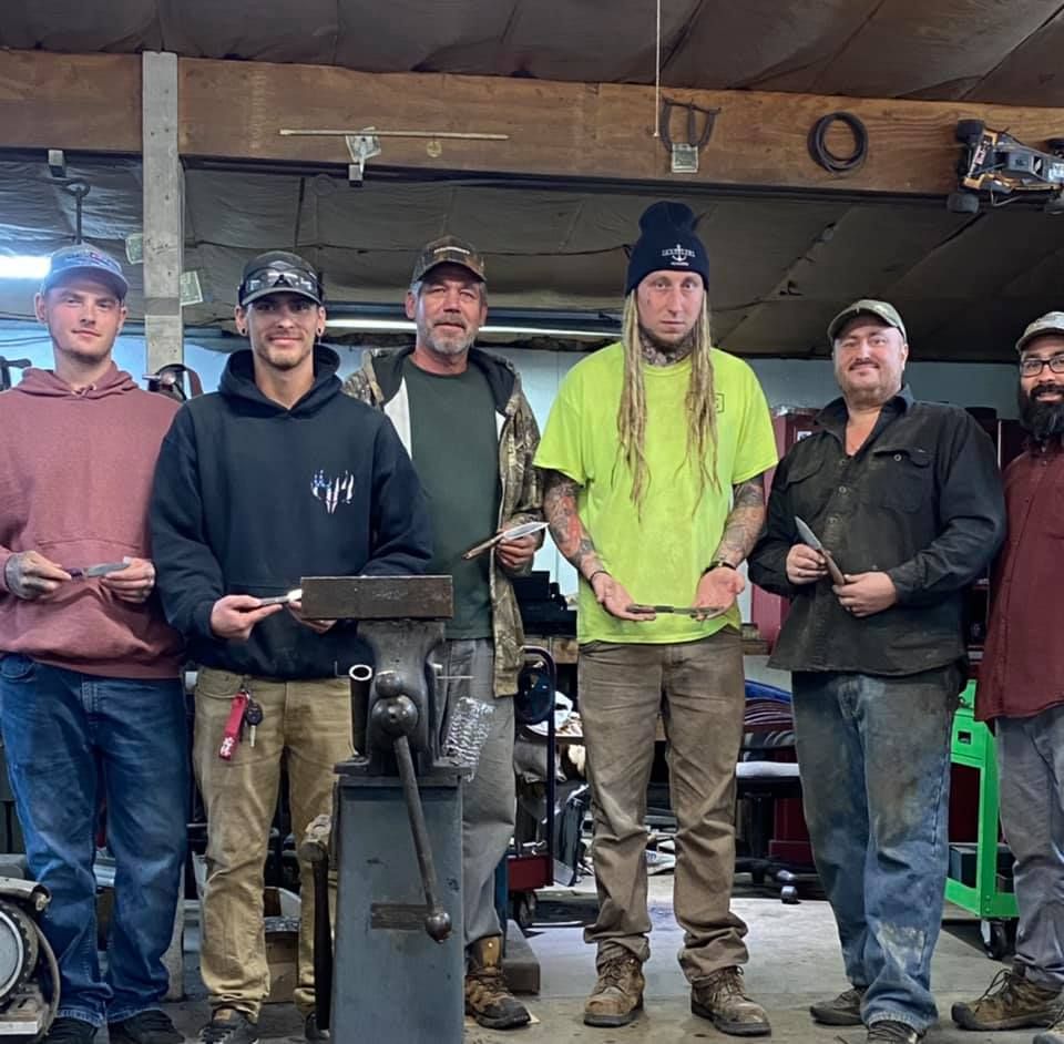 A group of men are posing for a picture in a garage