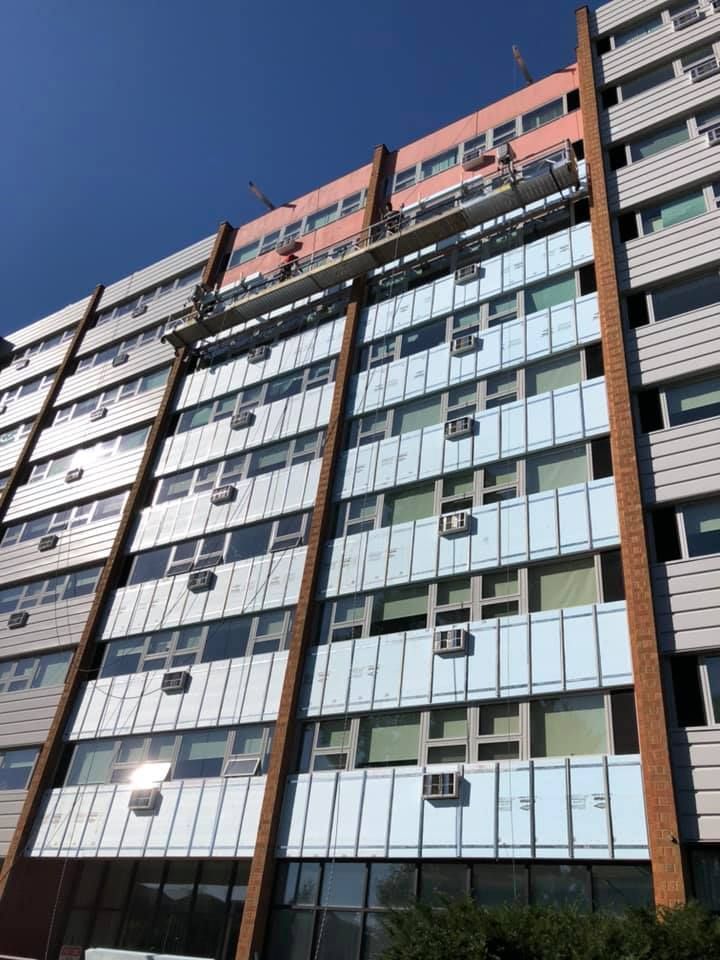 A tall building with a lot of windows and balconies