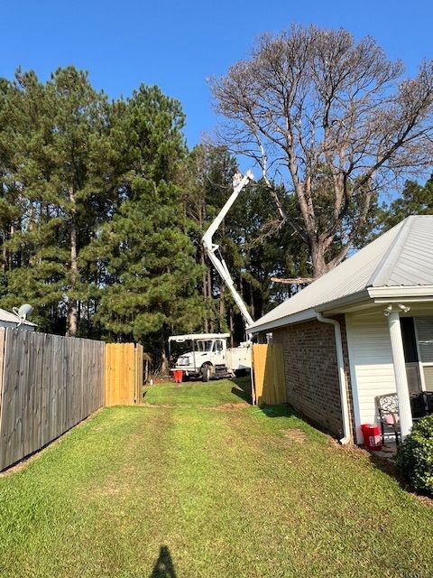 A white truck is parked in front of a house.