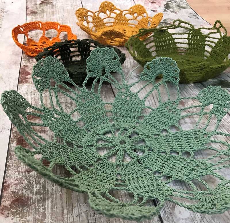 A picture of several hand made bowl shaped crochets for storing items