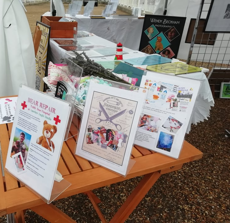 Small stands on a table describing some of the features Another Angle Studio provide to customers