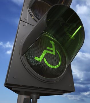 green traffic light with wheelchair pattern