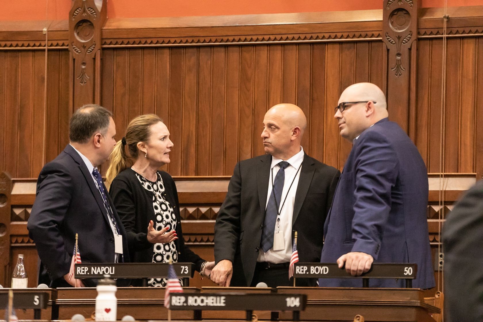 DiGiovancarlo and group of people at the State Capital talking to each other.