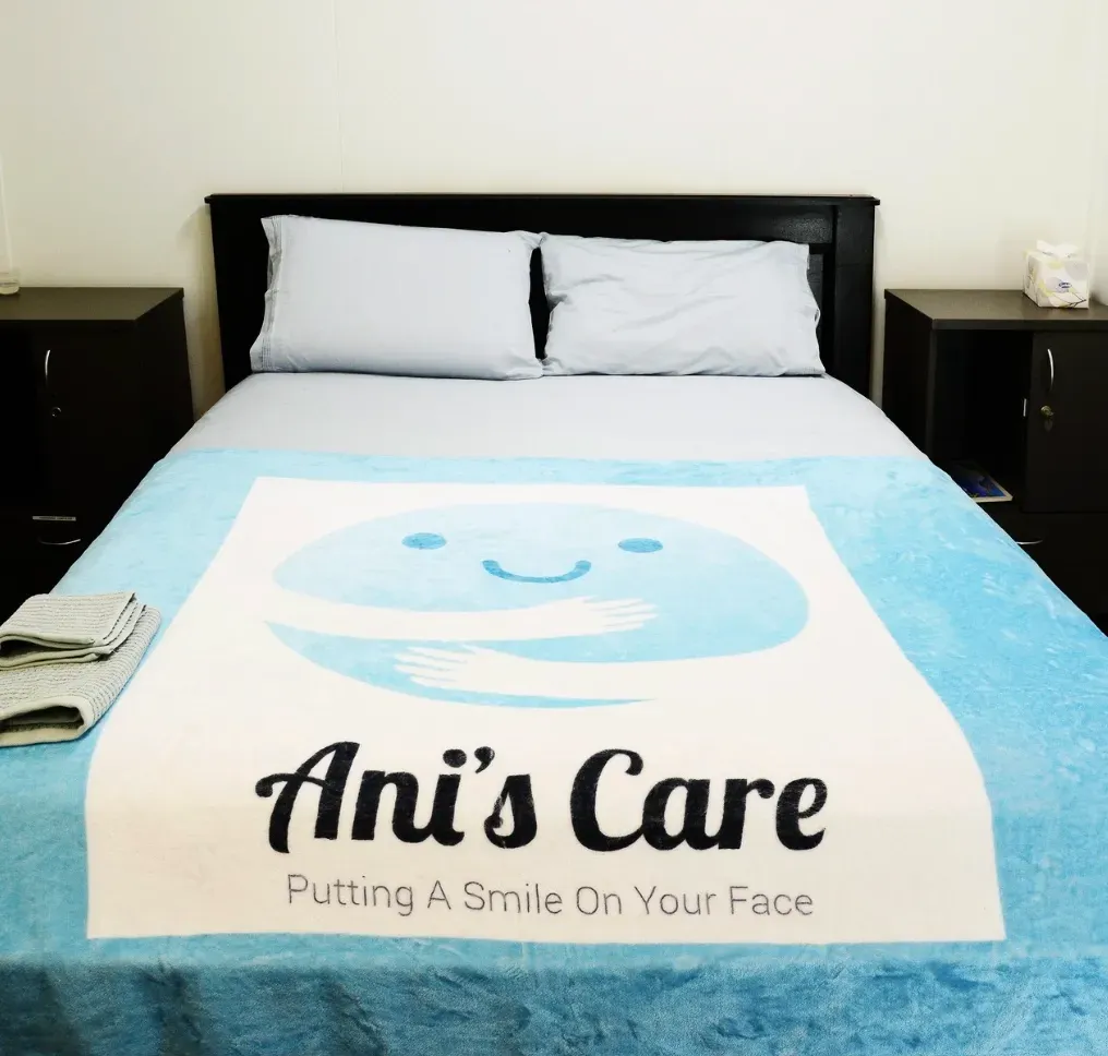 A Bed Cover With Ani's Care Logo — Ani's Care Pty Ltd In Millner, NT