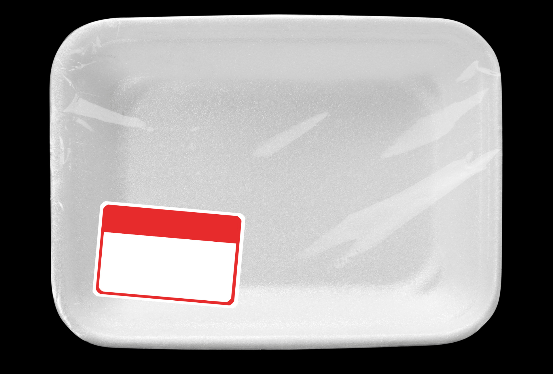 An empty styrofoam tray with a red label on it