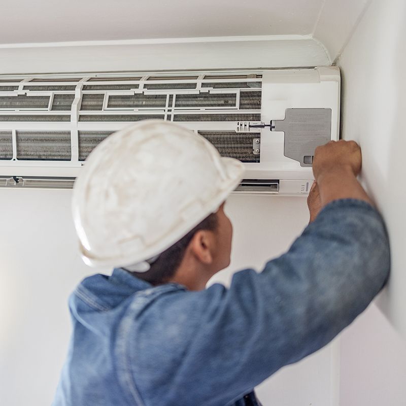 Worker Checking The Air Conditioner