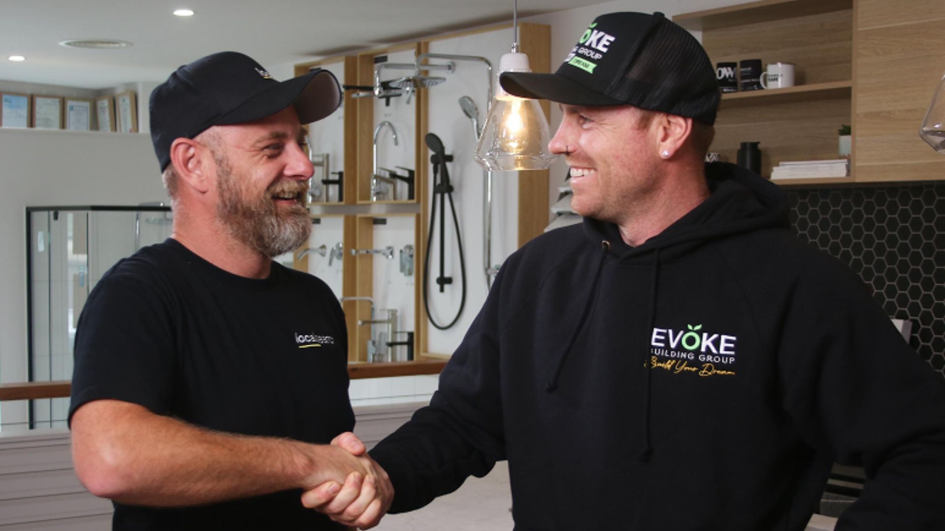 Two Men are Shaking Hands in a Kitchen