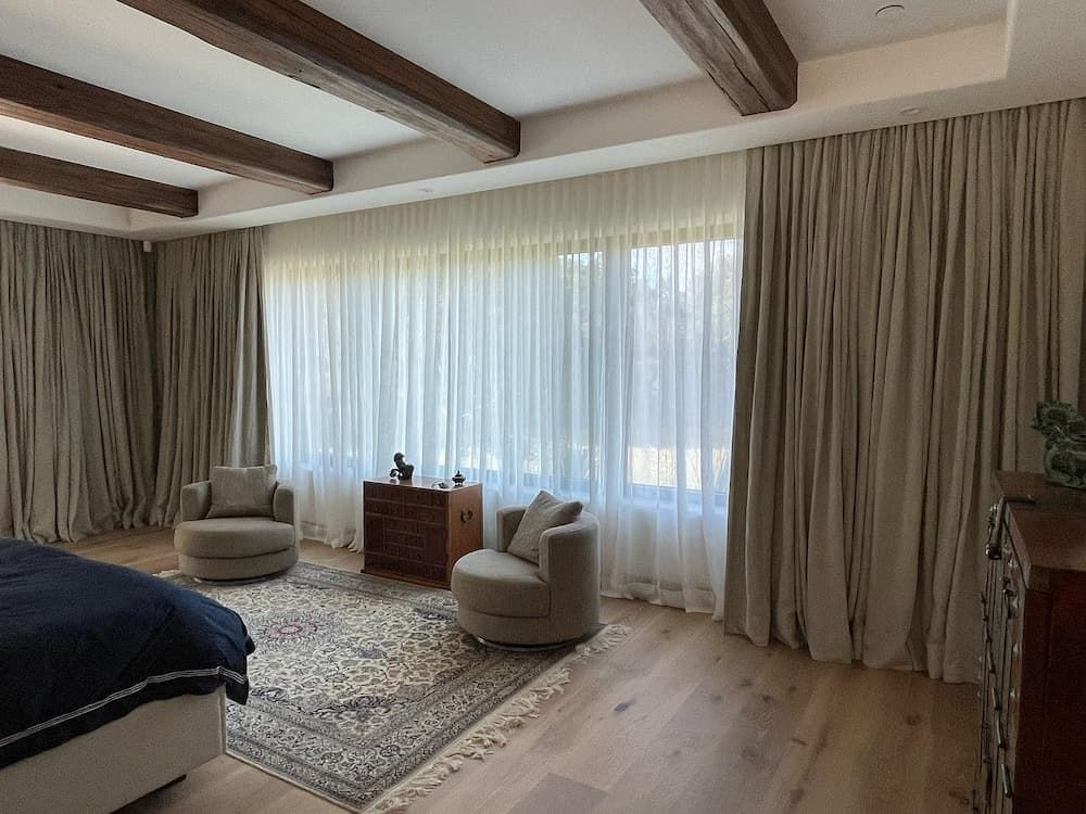 A Cozy Bedroom With Exposed Wooden Beams