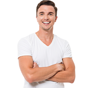 Man in white v-neck shirt, arms crossed, smiling.