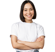 Woman with short, dark hair smiles with arms crossed, wearing a white t-shirt.