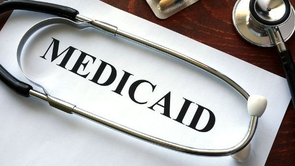A stethoscope is laying on a piece of paper that says medicaid
