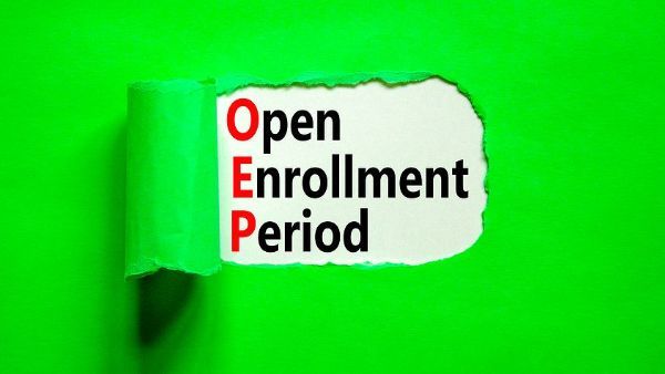 a piece of torn paper with the words open enrollment period written on it .