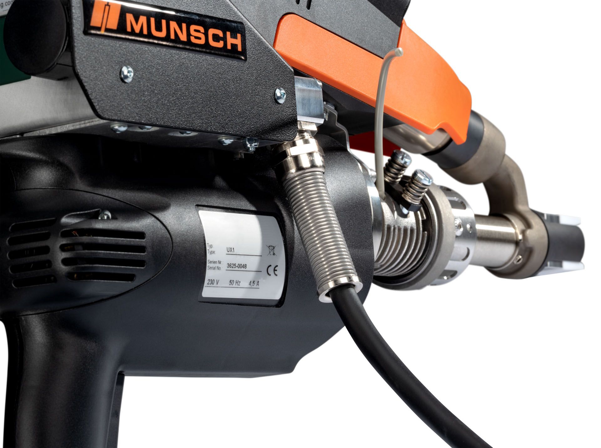 Primer plano de una herramienta de soldadura Munsch con componentes negros y naranjas, conectados por una manguera flexible.