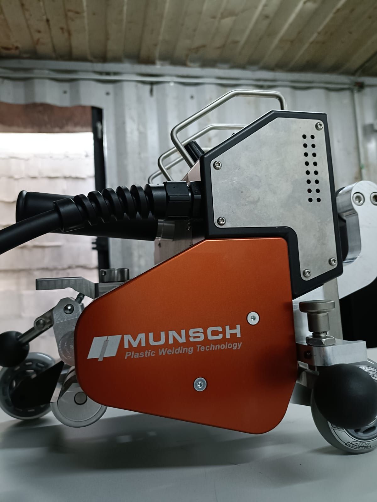 Máquina de soldar de color naranja y plata con el nombre 