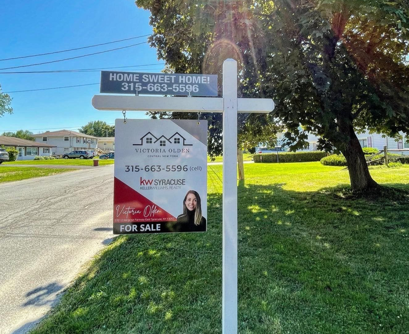 Real estate for sale sign by Victoria Olden, Central New York Realtor, displayed in a residential neighborhood.