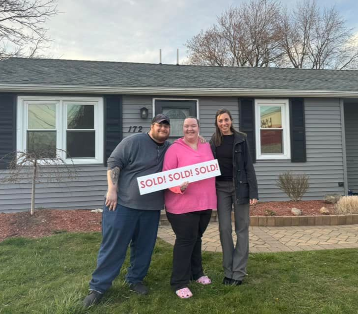 Couple standing outside their new home, looking at a modern house during sunset after moving in.