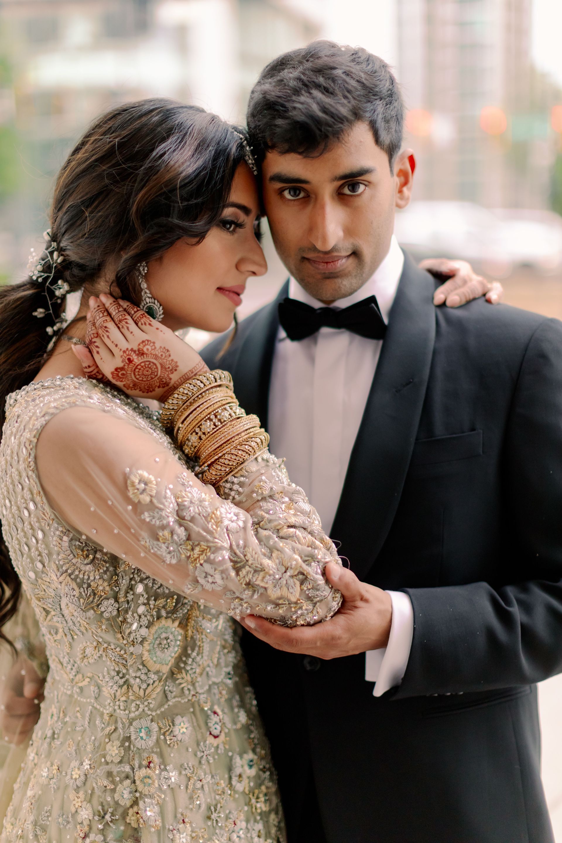A bride and groom are posing for a picture on their wedding day.
