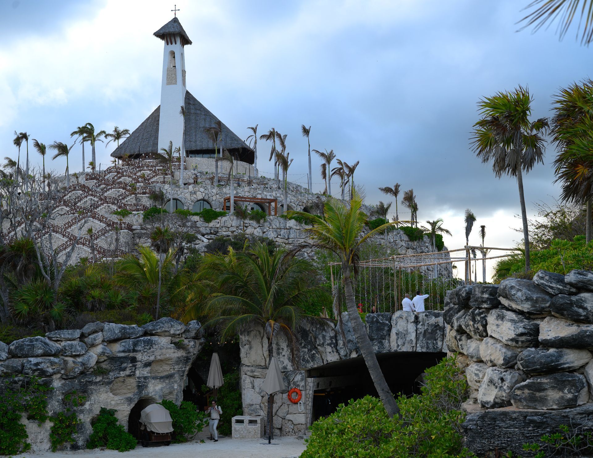 A small white building on top of a rocky hill