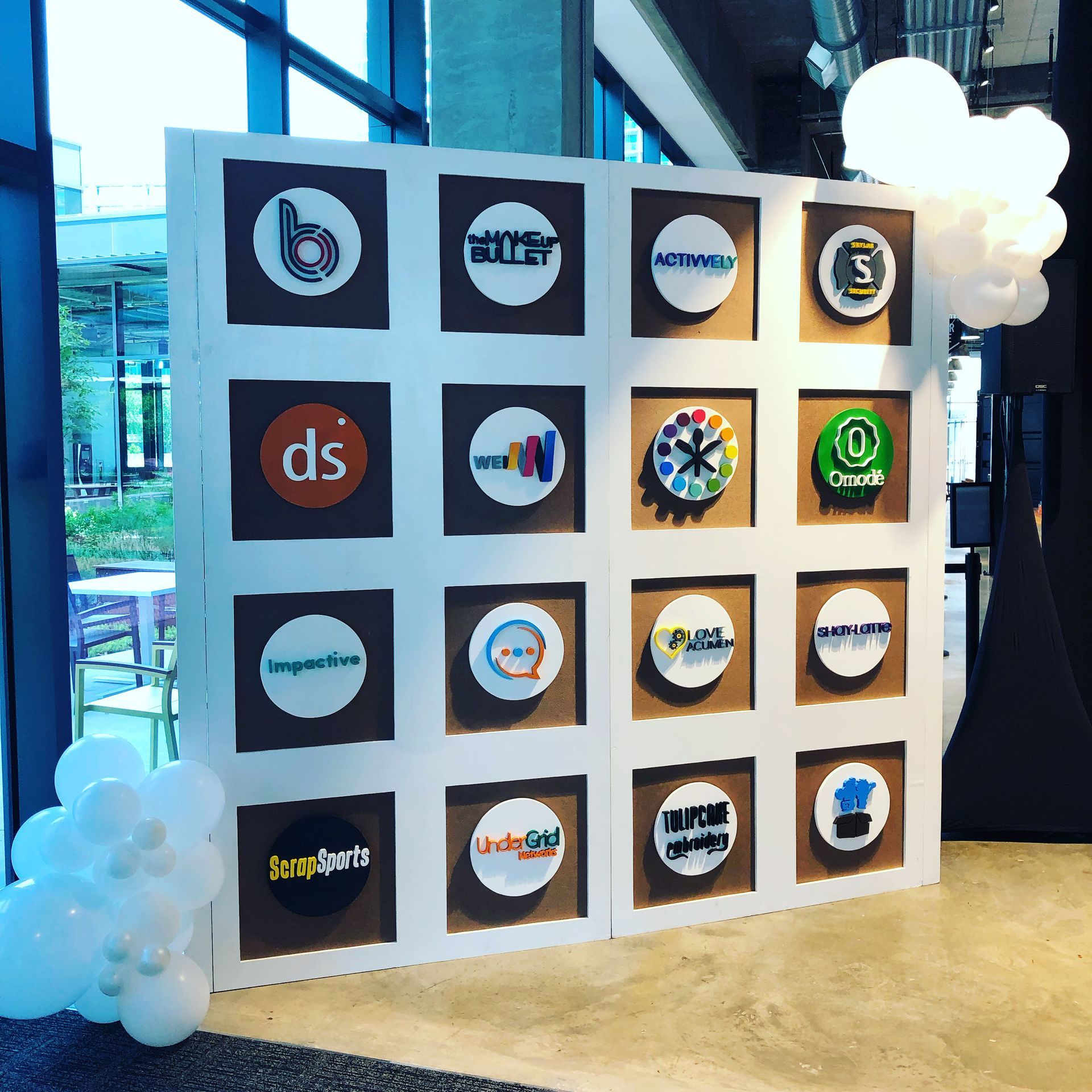 a wall with a lot of logos on it including one that says ds