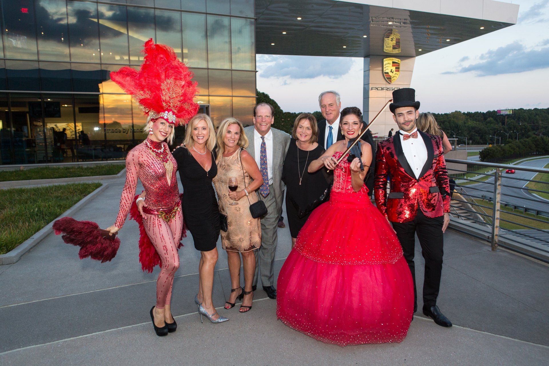 A group of people are posing for a picture in front of a building.