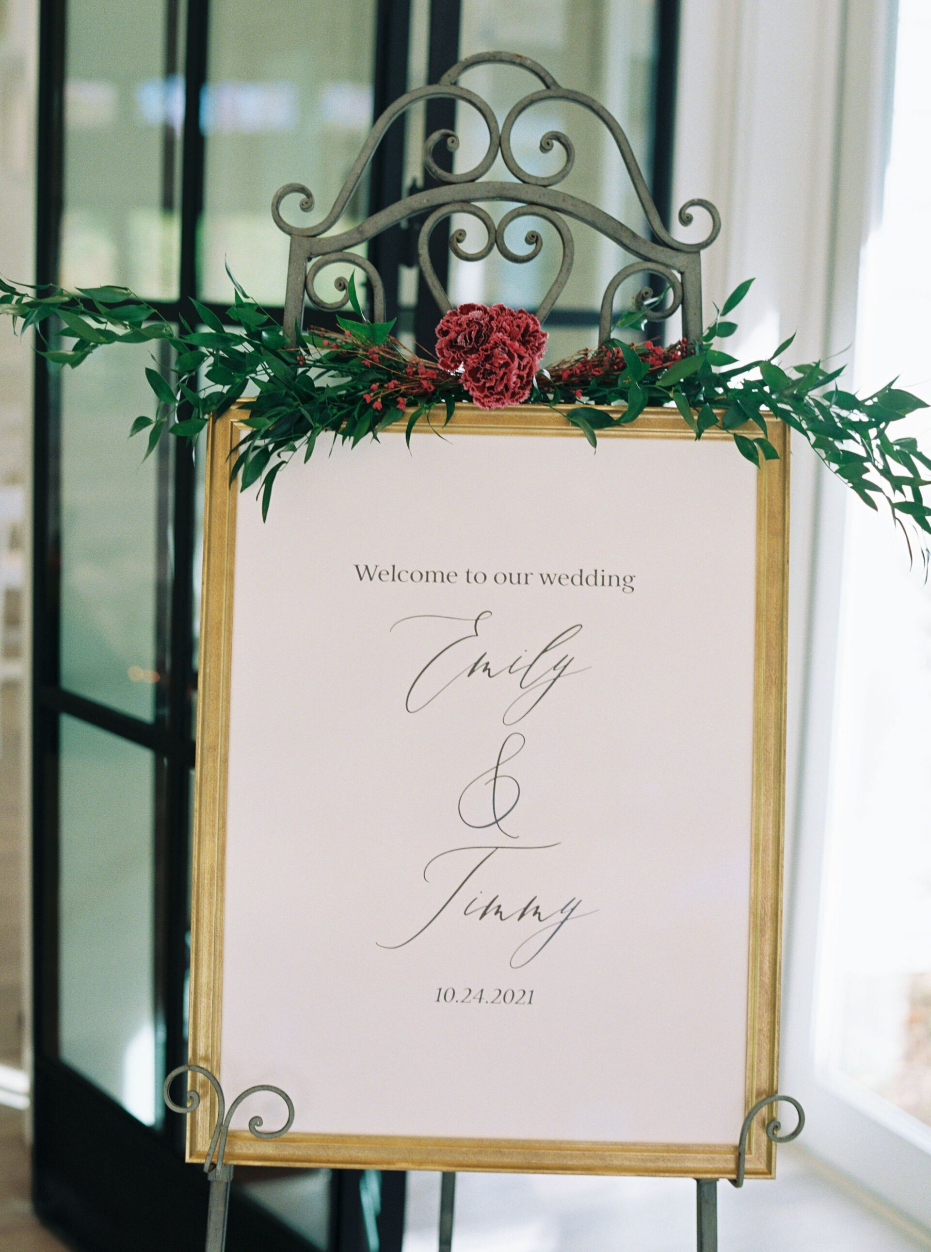 A white sign is sitting on top of a metal easel.